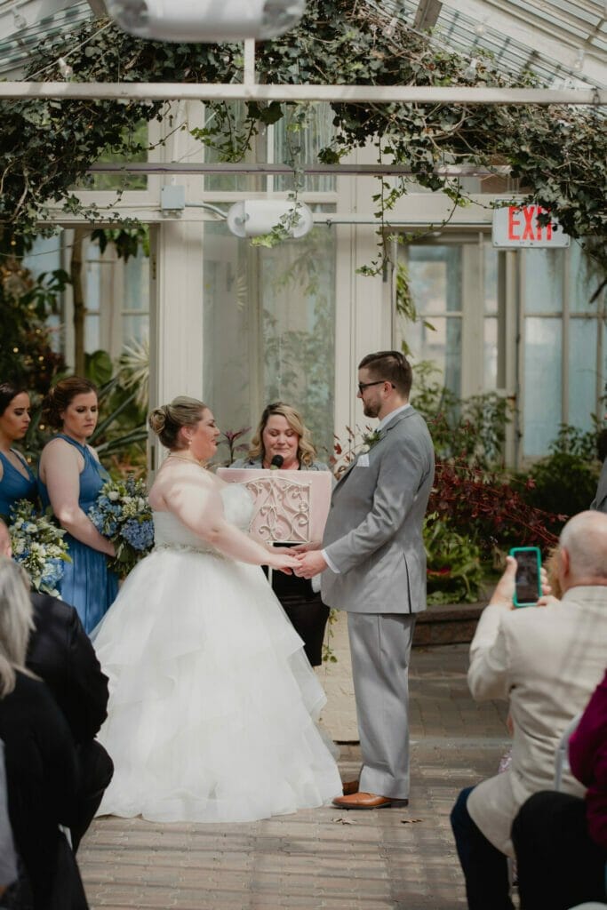 bride and groom hold hands botanical gardens
