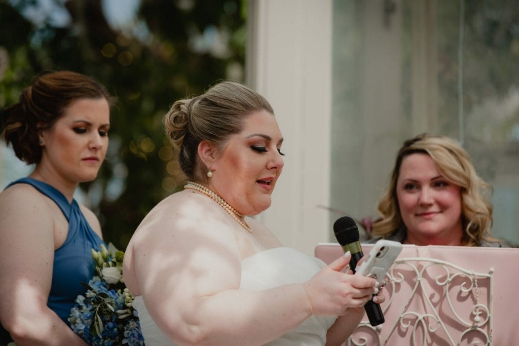 bride reading vows at botanical gardens
