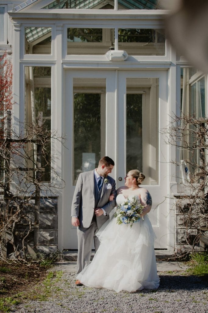 groom and bride outside of botanical gardens