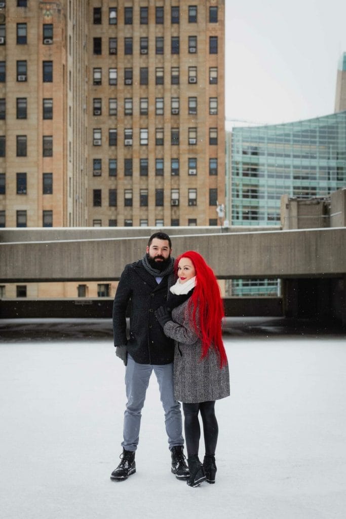 couple poses in front of buffalo town hall on turner ramp