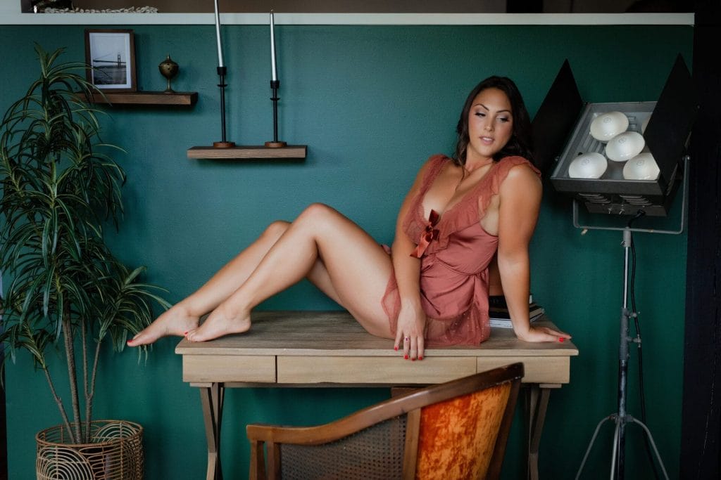 woman posing on table in romper